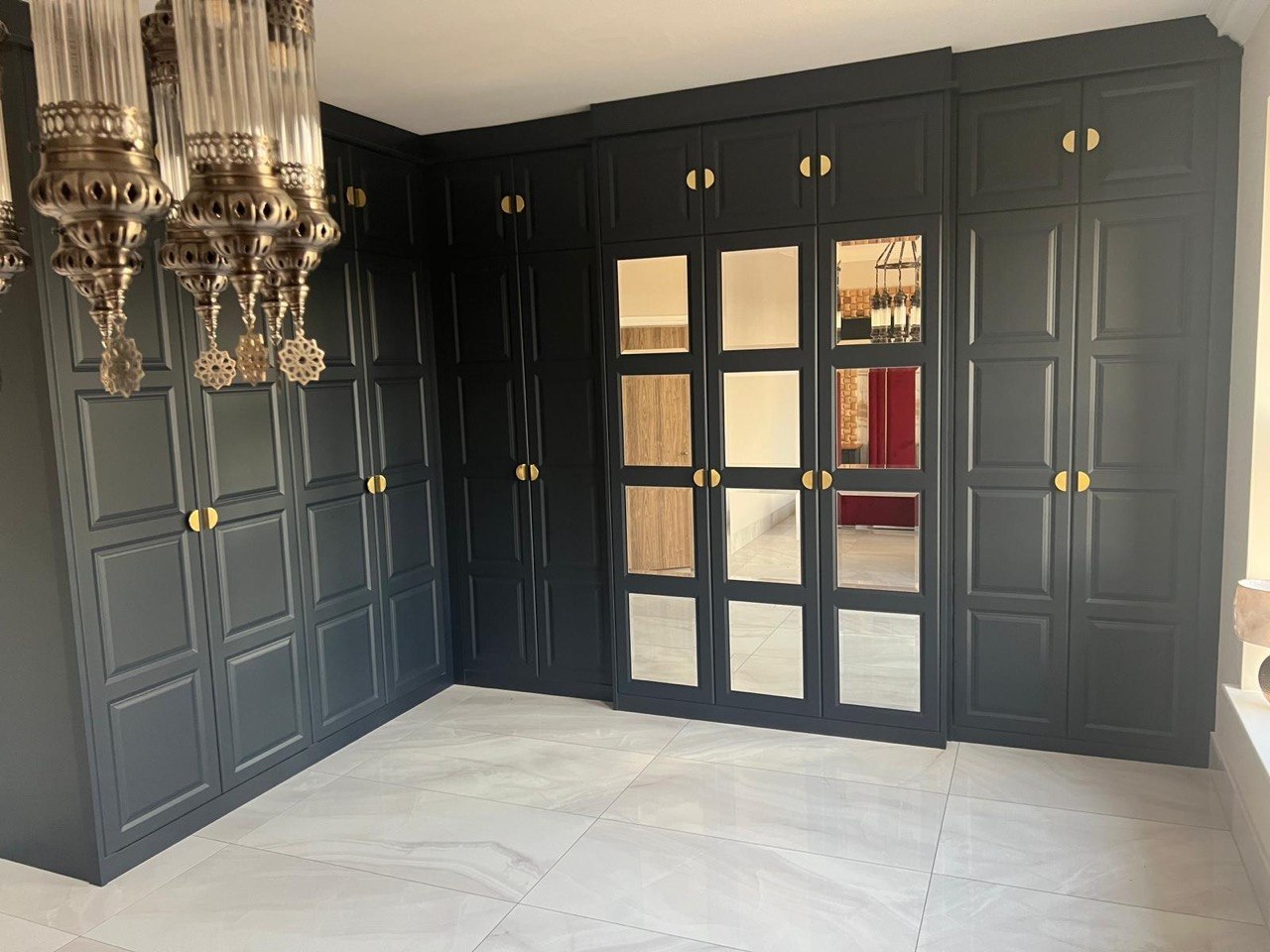 Completed MALCON full-height bespoke fitted wardrobe with brass handles and mirrored centre doors